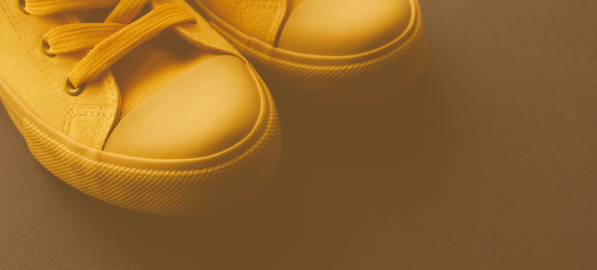 Yellow sneakers on a yellow background