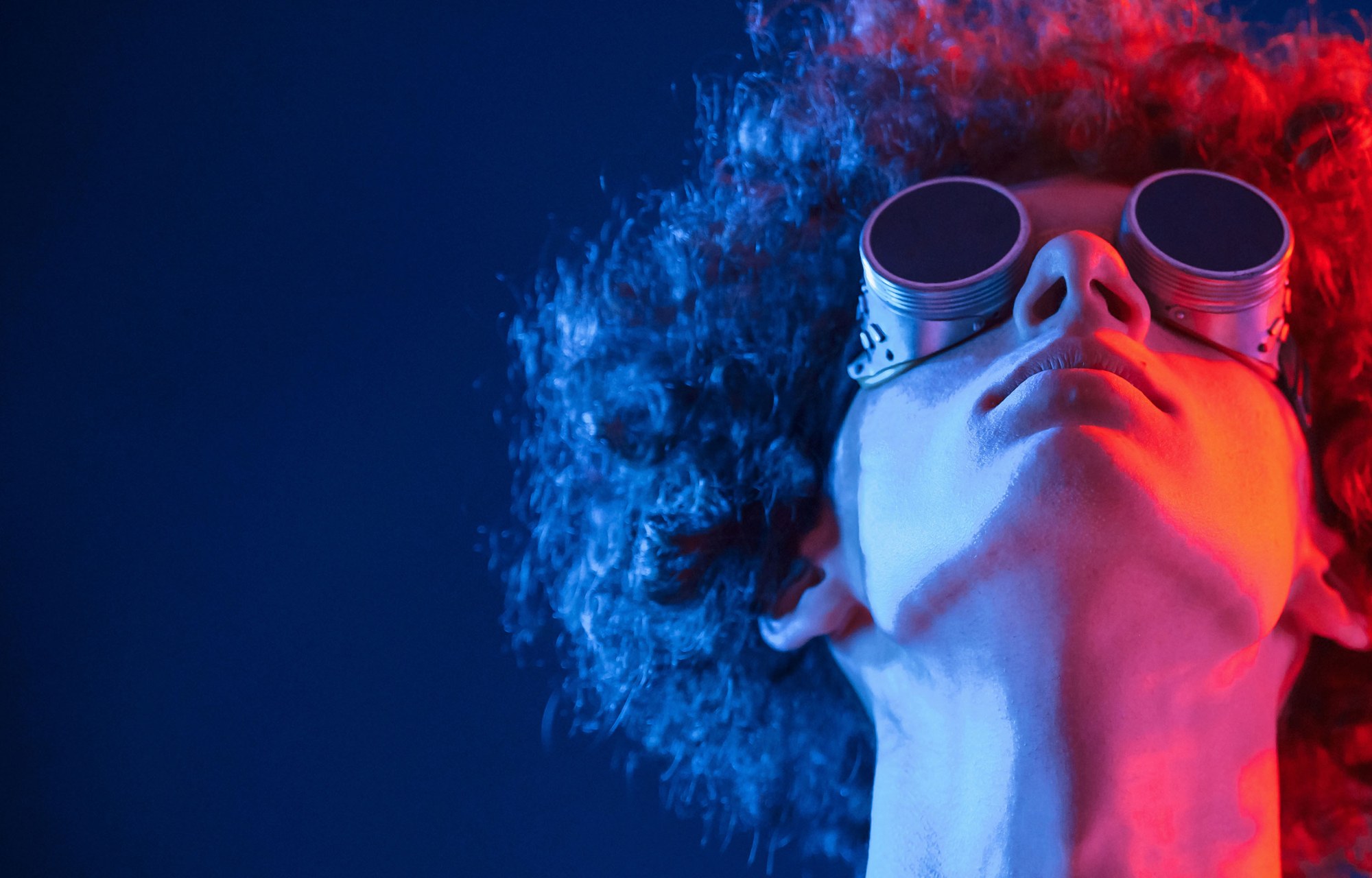 Portrait with round goggles in blue and red light